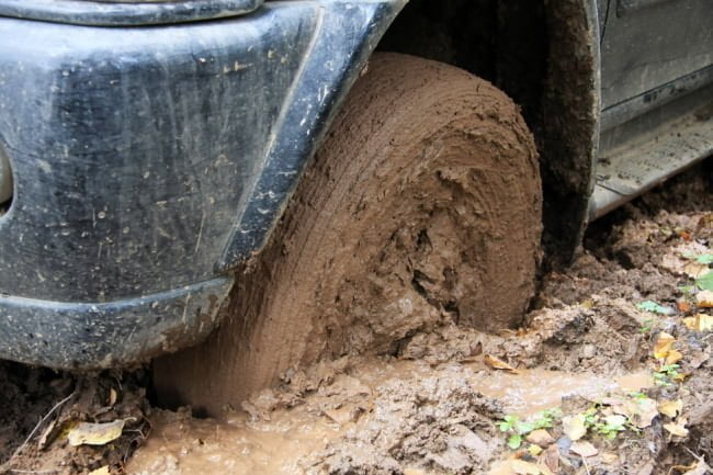 car tyre bogged down in mud