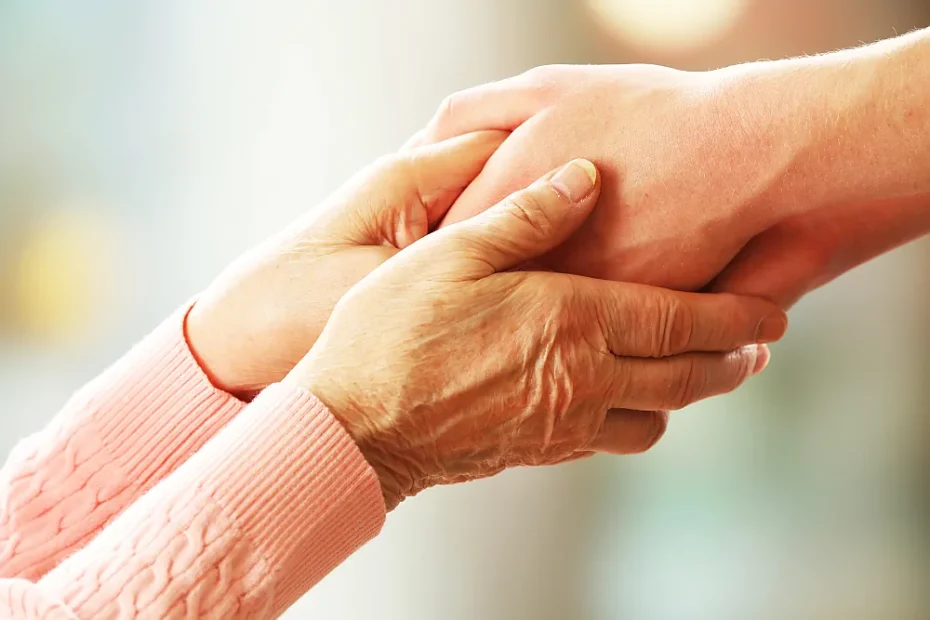 close-up of older and younger woman's clasped hands